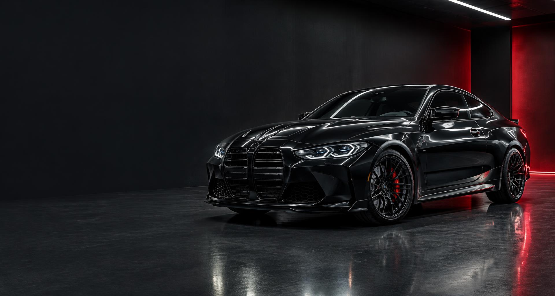Glossy black performance coupe in a detailing studio